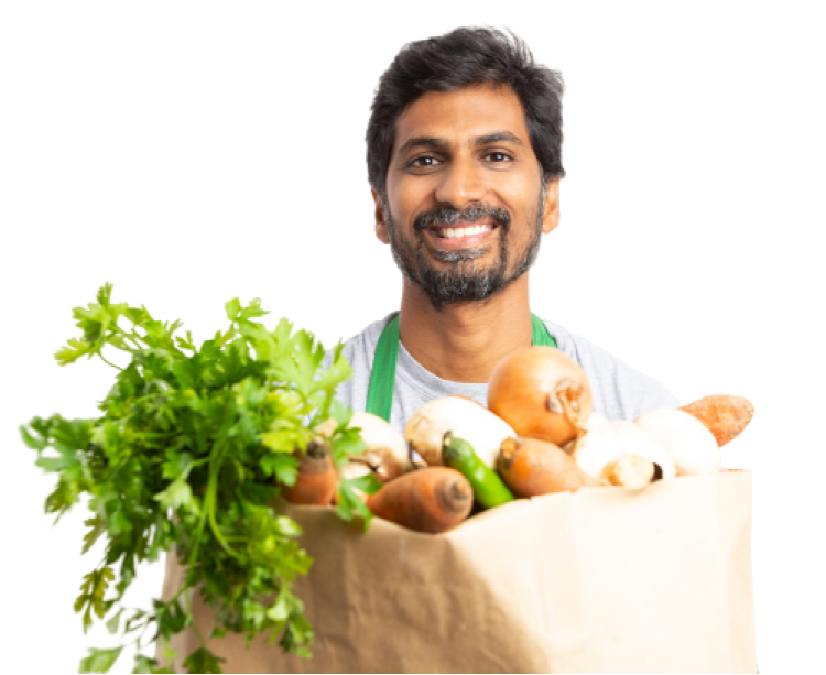 A guy holding a brown paper pack of veggies